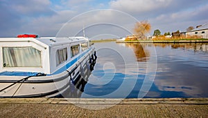 Holiday cruiser moored on the River Yare, Acle, Norfolk