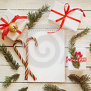 Holiday Decor Notebook for Message with gift, present box and candy cane. Christmas Background. Top view