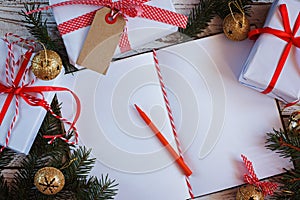 Holiday Decor Notebook for Message with gift, present box and gold jingle bell. Christmas Background. Top view