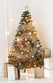 Holiday decorated room with Christmas tree and decoration, background with blurred, sparking, glowing light.