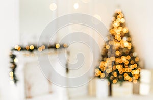 Holiday decorated room with Christmas tree and decoration, background with blurred, sparking, glowing light.