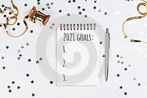 Holiday decorations and notebook with new year resolutions list