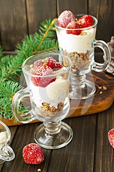 Holiday dessert cheesecake with strawberry in glass pubs, vertical bright image