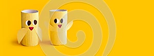 Holiday easy DIY craft idea for kids. Toilet paper roll tube toy\'s cute chick on yellow background banner