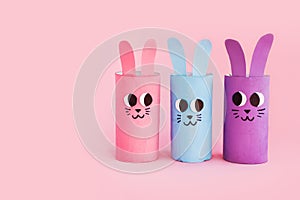 Holiday easy DIY craft idea for kids. Toilet paper roll tube toy\'s cute rabbit\'s on pink background