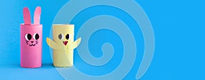 Holiday easy DIY craft idea for kids. Toilet paper roll tube toy\'s rabbit and chick. Blue background banner