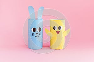 Holiday easy DIY craft idea for kids. Toilet paper roll tube toy\'s rabbit and chick. Pink background banner