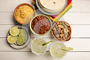 Glasses of Margaritas and chicken taco ingredients fiesta party photo