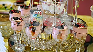 Holiday Furshet table colorful fruit dessert cream and souffle in glass. wedding celebratory dinner food design. concept of profes