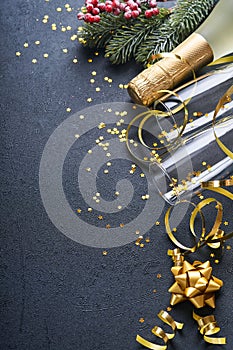 Holiday gift box or present with ribbon, golden confetti and gold baubles on black background. Magic christmas greeting card. Chri