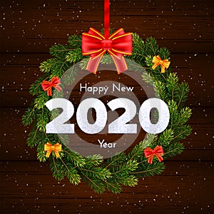 Holiday gift card. Happy New Year 2020. Snow numbers, fir tree branches wreath and bow on wood background. Celebration decor.