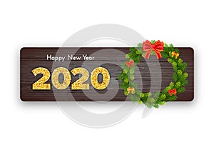 Holiday gift card Happy New Year. Golden numbers 2020, fir tree branches wreath and red tied bow on wood background. Celebration