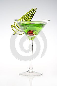 A Holiday Green Appletini with tree decor on the side.