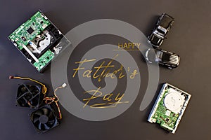 Holiday greeting card for Father`s Day on a black background - machines, computer boards, with the text - Happy Father`s Day