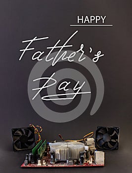 Holiday greeting card for Father`s Day on a black background - machines, computer boards, with the text - Happy Father`s Day