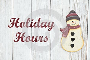 Holiday hours sign with snowman