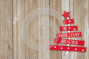 Holiday Hours sign on weathered wood