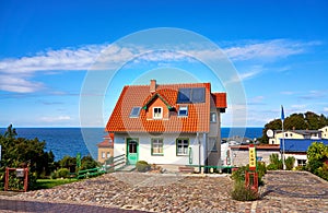 Holiday house with red roof tiles and solar panels. Living overlooking the Baltic Sea on the island of RÃ¼gen