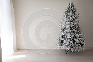 Holiday Interior White Christmas tree with gifts and decorations garlands of lights new year