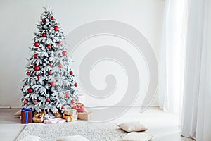 Holiday Interior White Christmas tree with gifts and decorations garlands of lights new year