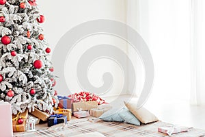 Holiday Interior White Christmas tree with gifts and decorations garlands of lights new year