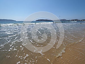 Holiday landscape of sandy beach at bay of ACAPULCO city in Mexico with white waves of Pacific Ocean