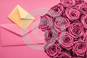 Holiday love letter and flowers delivery, luxury bouquet of roses and card on blush pink background for romantic holiday design