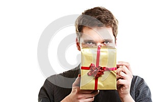 Holiday. Man giving golden gift box with ribbon