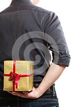 Holiday. Man hiding surprise gift box behind back