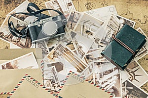 Holiday memories. Vintage postcards with a map, photo camera and travel notebook