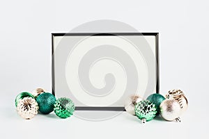 Holiday mock up. black frame with blank white background for text. christmas decor green and gold, copy space