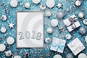 Holiday mockup or invitation. New year background. Silver frame with christmas decoration, gift box, white confetti and sequins.