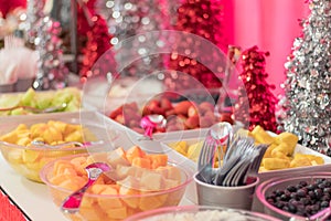 Holiday Party food desserts decorated festively with fresh fruit strawberries, pineapple, melon