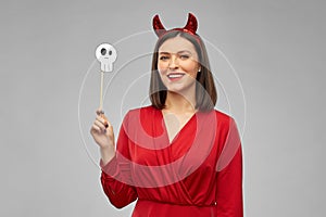 Happy woman in red halloween costume of devil