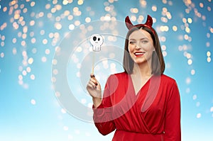 Happy woman in red halloween costume of devil