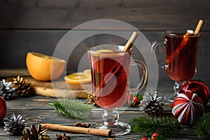 A holiday photo of a glass of mulled wine with orange, anise and cinnamon. Cozy Christmas atmosphere