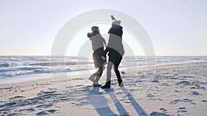 Holiday pictures, joyful women have fun on embankment and are photographed on smartphone