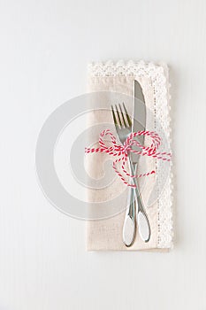 Holiday place seting with napkin, fork and knife.