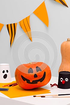 Holiday preparation and handmade party decor. Halloween indoor activity, pumpkin painting