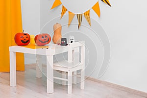 Holiday preparation and handmade party decor. Halloween indoor activity, pumpkin painting