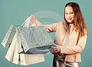 Holiday purchase saving. Sales and discounts. Kid fashion. shop assistant with package. Small girl with shopping bags