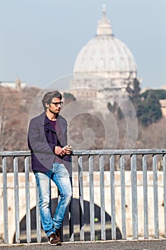 Holiday in Rome, Italy. Handsome young trendy on the bridge.