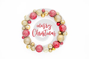 Holiday round frame made of red and gold glass Christmas balls isolated on a white background. the apartment lay, top