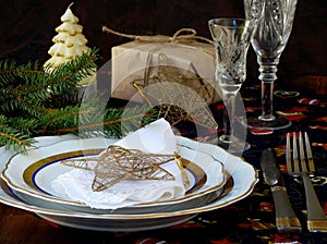 Holiday rustic Christmas and New Year table setting with xmas decorations at dark wooden table.