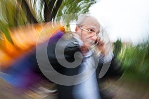 Holiday sales. An elderly man with many shopping bags in his han