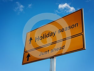 Holiday season road sign background sky.