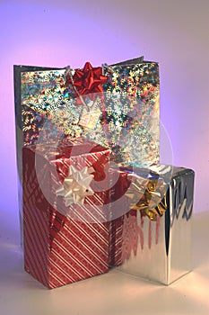 Holiday shopping bags and gift boxes on white background