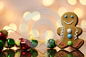 Gingerbread man and holiday jinglebells on a bokeh background photo
