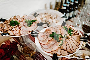 The holiday table with appetizer, meat snacks. Served table with food. Festive table. Wedding table, food. Table at restaurant