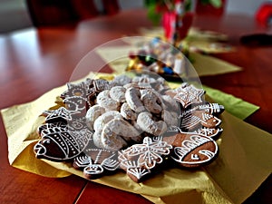 holiday table with gingerbread sweets and vanilla rolls. everything is